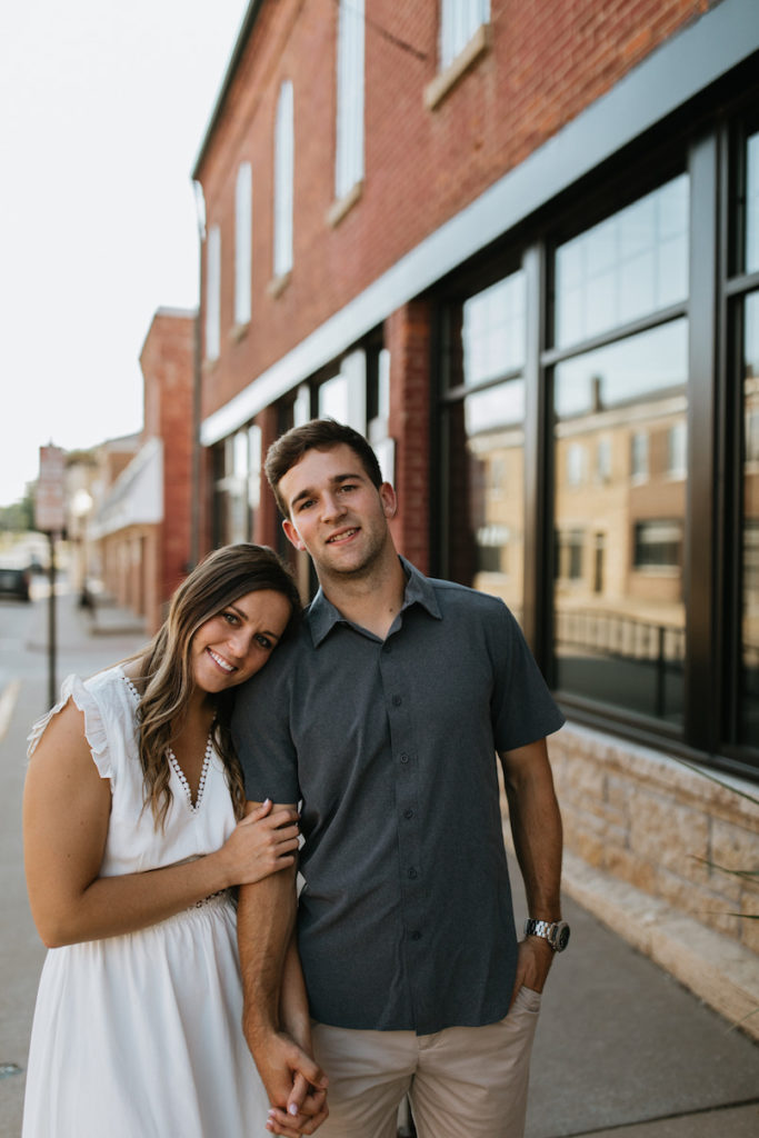 Couple engagement photo session on main street in Bellevue, Iowa. 
