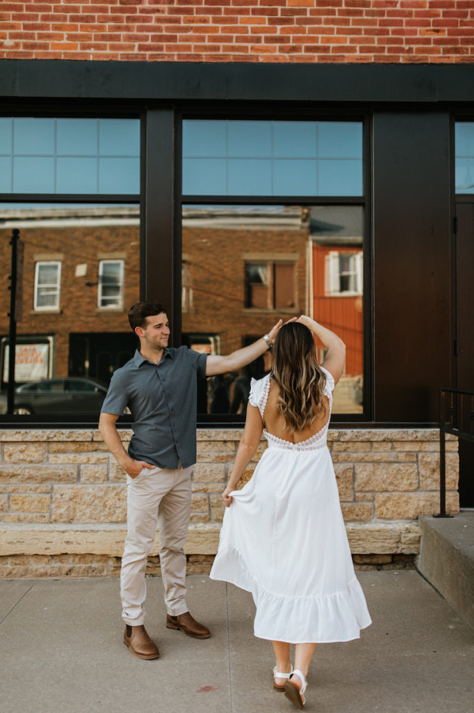 Couple engagement photo session on main street in Bellevue, Iowa. 