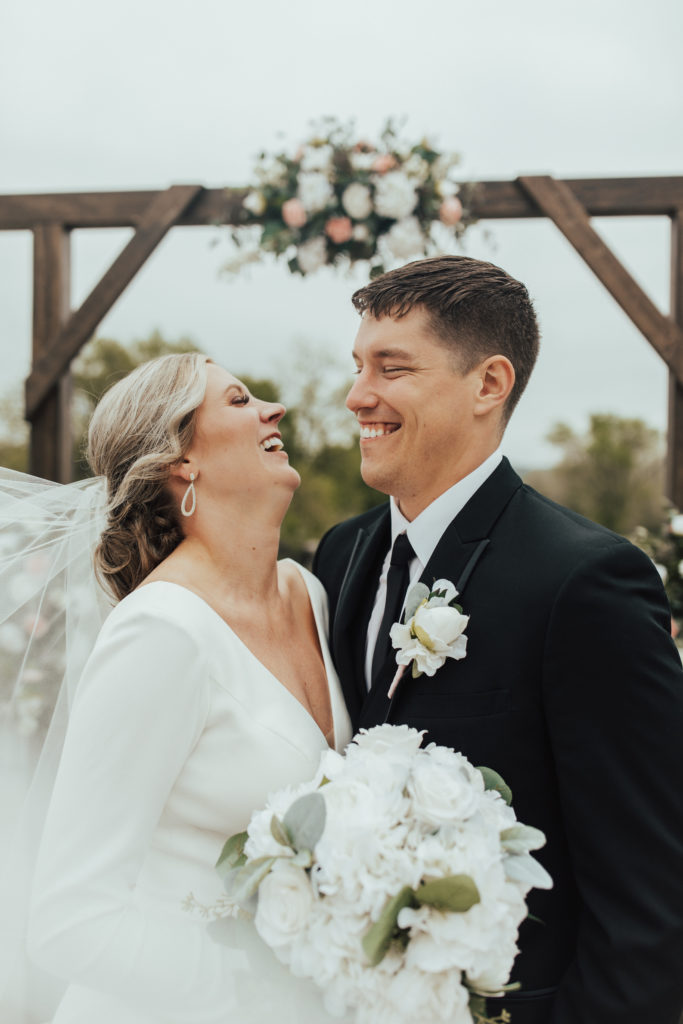 Elegant bride and groom first-look in front of their wedding arch at the Dousman House in Prairie du Chien, WI.