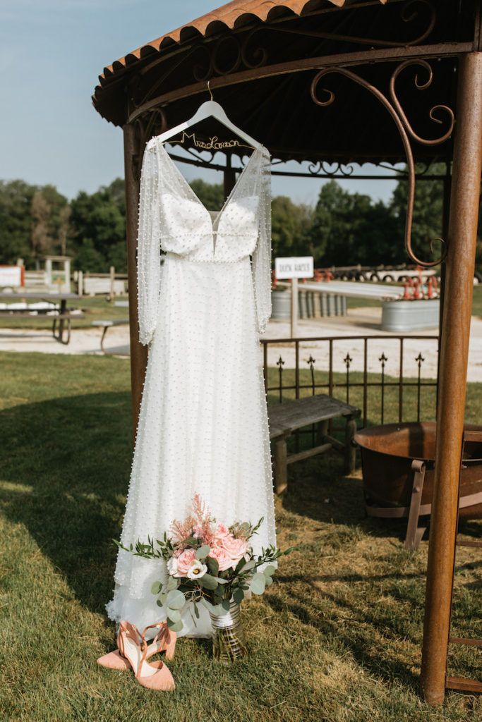 Wedding dress hanging on a custom hanger. 