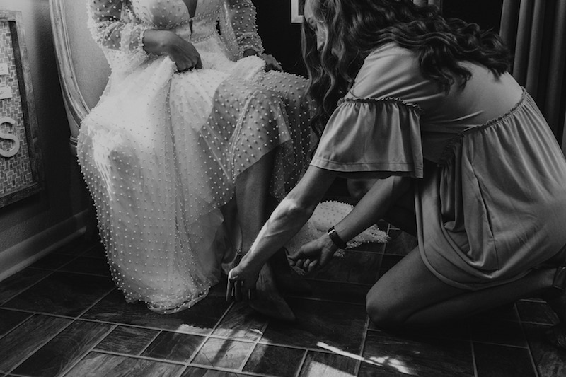 Bride getting ready putting on her shoes. 