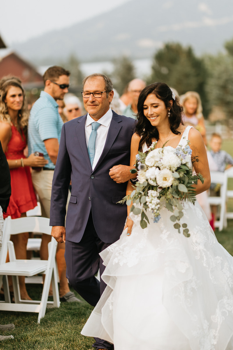 Father walking his daughter down the aisle at her wedding. 