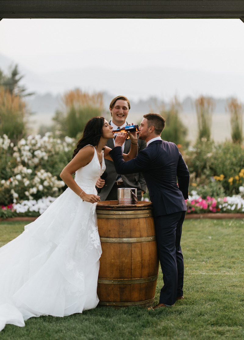 Bride and groom sharing a unity beer at their intentional wedding ceremony. 