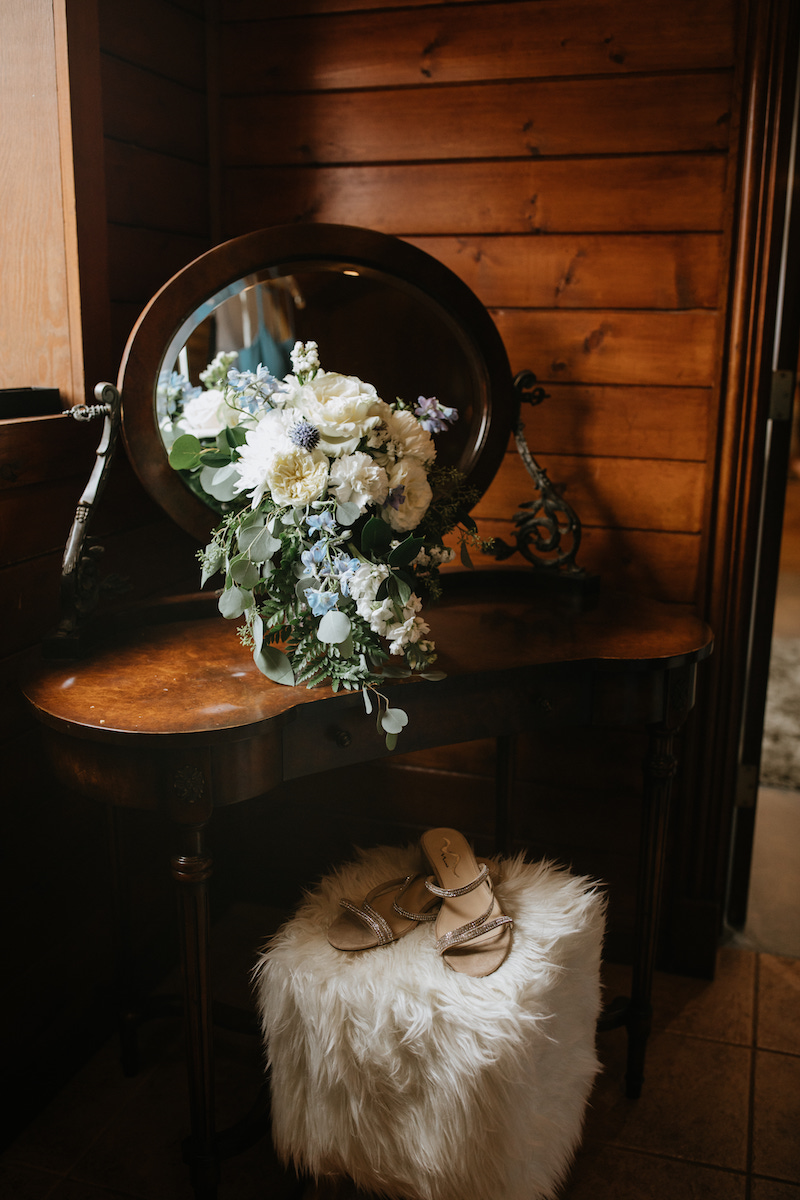 Intentional bridal details- oversized bouquet, heels and vanity. 