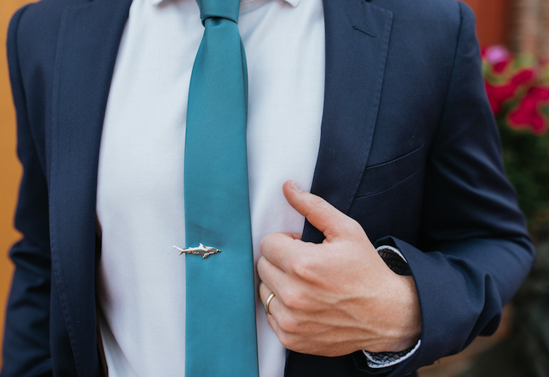 Teal tie and shark tie pin. 