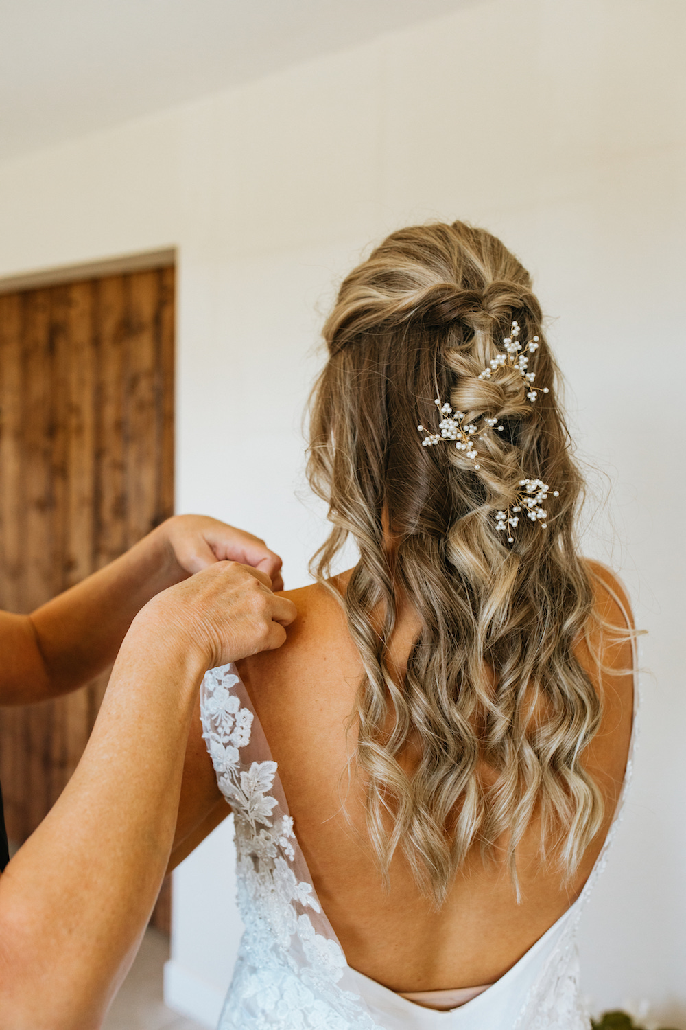 Half-up bridal hair with a twisted braid and babies breath. 