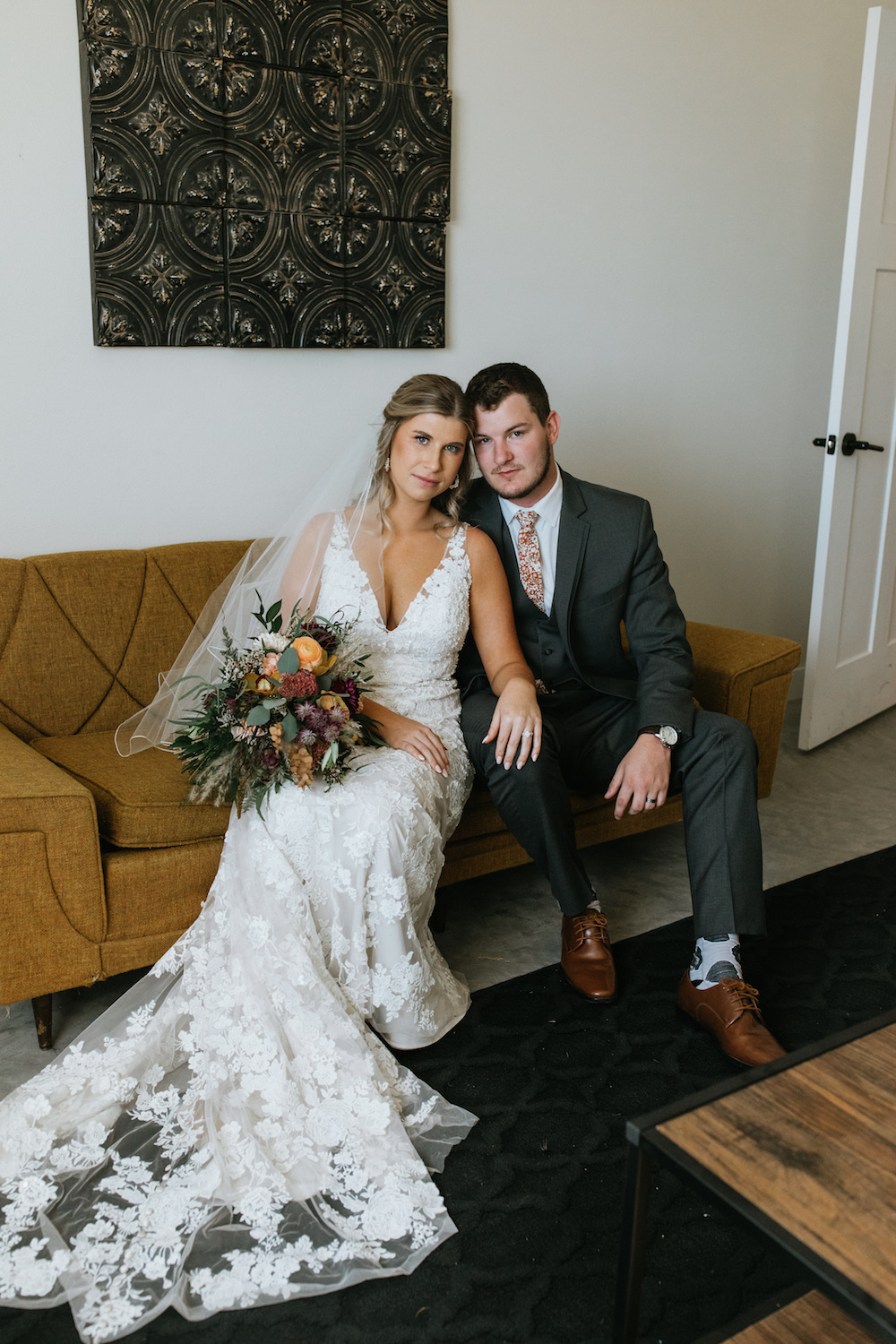 Fall wedding bride and groom portraits on a yellow mid-century couch. 